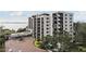 Modern high-rise condo building surrounded by trees and a circular driveway at 4 Belleview Blvd # 801, Belleair, FL 33756