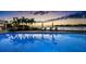 Community pool with serene evening ambiance and palm trees at 4 Belleview Blvd # 801, Belleair, FL 33756