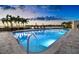 Inviting community pool at sunset with waterfront views at 4 Belleview Blvd # 801, Belleair, FL 33756