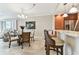 Dining area with elegant chandelier, glass-top table, and view of the kitchen at 4 Belleview Blvd # 801, Belleair, FL 33756