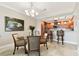 Dining area featuring a glass table with wooden chairs and a view into the kitchen at 4 Belleview Blvd # 801, Belleair, FL 33756