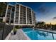 Modern condo building with pool at sunset at 4 Belleview Blvd # 801, Belleair, FL 33756