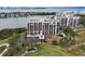 Aerial view of a waterfront condo building with a golf course and nearby marina at 4 Belleview Blvd # 801, Belleair, FL 33756