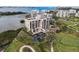 High-rise condo building with parking, overlooking a lush green golf course and water at 4 Belleview Blvd # 801, Belleair, FL 33756