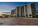 Modern condo building exterior with circular driveway and landscaping at 4 Belleview Blvd # 801, Belleair, FL 33756