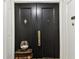Dark double doors with a brass knocker and handle, and a decorative glass bowl at 4 Belleview Blvd # 801, Belleair, FL 33756