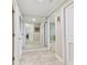 Spacious hallway with large mirror and tiled flooring leading to other rooms at 4 Belleview Blvd # 801, Belleair, FL 33756