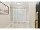 Hallway with white louvered closet doors and tiled flooring at 4 Belleview Blvd # 801, Belleair, FL 33756