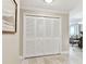 Hallway with white louvered doors and tiled floor, leading to living space at 4 Belleview Blvd # 801, Belleair, FL 33756