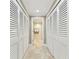 Hallway with ample closet space and tile flooring at 4 Belleview Blvd # 801, Belleair, FL 33756