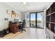 Spacious home office featuring a desk, bookshelves, and balcony access at 4 Belleview Blvd # 801, Belleair, FL 33756