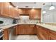 Modern kitchen featuring stainless steel appliances, wood cabinetry, and granite countertops at 4 Belleview Blvd # 801, Belleair, FL 33756