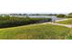 Lush green lawn leading to the waterfront with a metal handrail at 4 Belleview Blvd # 801, Belleair, FL 33756