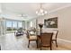 Living and dining area with tile flooring, balcony access, and water views at 4 Belleview Blvd # 801, Belleair, FL 33756