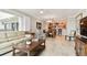 Living room with a view of the kitchen and dining area, leading to a balcony at 4 Belleview Blvd # 801, Belleair, FL 33756