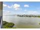 Panoramic water view showcasing coastal homes, boats, and lush greenery under a clear blue sky at 4 Belleview Blvd # 801, Belleair, FL 33756