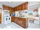 Kitchen boasts granite counters, wooden cabinets, and built-in banquette at 4227 6Th N Ave, St Petersburg, FL 33713