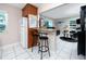 Kitchen with breakfast bar, view of living room, and granite counters at 4227 6Th N Ave, St Petersburg, FL 33713