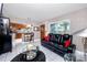 Living room with leather couch, coffee table, and view into kitchen at 4227 6Th N Ave, St Petersburg, FL 33713