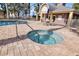 Community pool and hot tub area with lounge chairs and umbrellas at 425 150Th Ave # 2201, Madeira Beach, FL 33708