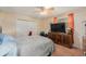 Bedroom with ceiling fan, flat-screen TV, and wood flooring at 44 Pinewood Cir, Safety Harbor, FL 34695