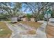 House exterior view, showcasing the driveway and landscaping at 44 Pinewood Cir, Safety Harbor, FL 34695