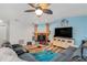 Living room with stone fireplace, TV, and hardwood floors at 44 Pinewood Cir, Safety Harbor, FL 34695