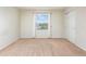 Empty bedroom with carpeted floors and a large window at 4770 White Sanderling Ct, Tampa, FL 33619