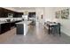 Stylish kitchen with island seating, dark wood cabinetry, and stainless steel appliances at 5047 Captain Davis Dr, Wimauma, FL 33598