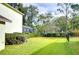 Landscaped backyard with lush green lawn at 5112 Twin Creeks Dr, Valrico, FL 33596