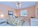 Bedroom with a floral-print bed and ceiling fan at 5112 Twin Creeks Dr, Valrico, FL 33596