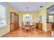 Bright dining area with hardwood floors and a wood dining set at 5112 Twin Creeks Dr, Valrico, FL 33596