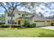 Two-story house with a large yard and a two-car garage at 5112 Twin Creeks Dr, Valrico, FL 33596