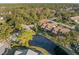 Aerial view showcasing a neighborhood with houses and lush greenery at 5577 Salem Square N Dr, Palm Harbor, FL 34685