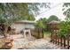 Backyard patio with shed, wooden fence, and a small grassy area at 628 Pine St, Tarpon Springs, FL 34689