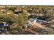 An aerial view of a house surrounded by lush trees and a paved driveway at 6301 Hobson Ne St, St Petersburg, FL 33702