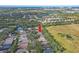 High-angle view of a neighborhood with a red arrow pointing towards a house at 6937 Exeter Park Pl, Apollo Beach, FL 33572