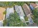 An aerial view of a home with a gray roof, driveway, and surrounding trees at 6937 Exeter Park Pl, Apollo Beach, FL 33572