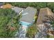 Aerial view of the property and surrounding neighborhood with mature trees at 6937 Exeter Park Pl, Apollo Beach, FL 33572