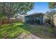 Fenced backyard with a screened-in porch and lush green lawn at 6937 Exeter Park Pl, Apollo Beach, FL 33572