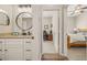Bathroom vanity with granite countertop and doorways to adjacent rooms at 6937 Exeter Park Pl, Apollo Beach, FL 33572