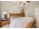 Bedroom with wooden sleigh bed, matching nightstand, and dresser at 6937 Exeter Park Pl, Apollo Beach, FL 33572