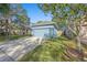 Blue house with two-car garage and lush landscaping at 6937 Exeter Park Pl, Apollo Beach, FL 33572