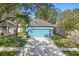 Charming blue home with a two-car garage and landscaped front yard at 6937 Exeter Park Pl, Apollo Beach, FL 33572
