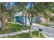 Quaint blue house with a welcoming front yard and palm trees at 6937 Exeter Park Pl, Apollo Beach, FL 33572