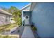 Front yard with blue exterior, palm tree and tropical landscaping at 6937 Exeter Park Pl, Apollo Beach, FL 33572