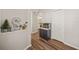 Hallway with wood-look flooring, an aquarium, and a view into a bathroom at 6937 Exeter Park Pl, Apollo Beach, FL 33572