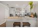 Bright, open kitchen with white cabinets, granite countertops, and breakfast bar at 6937 Exeter Park Pl, Apollo Beach, FL 33572