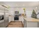Modern kitchen with white cabinets, granite countertops, and stainless steel appliances at 6937 Exeter Park Pl, Apollo Beach, FL 33572