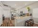 Updated kitchen featuring white cabinetry, granite counters, and stainless steel appliances at 6937 Exeter Park Pl, Apollo Beach, FL 33572